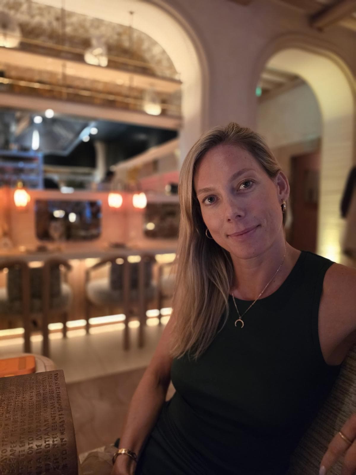 Tamaryn Small, founder of Tame & True, smiling at a restaurant table