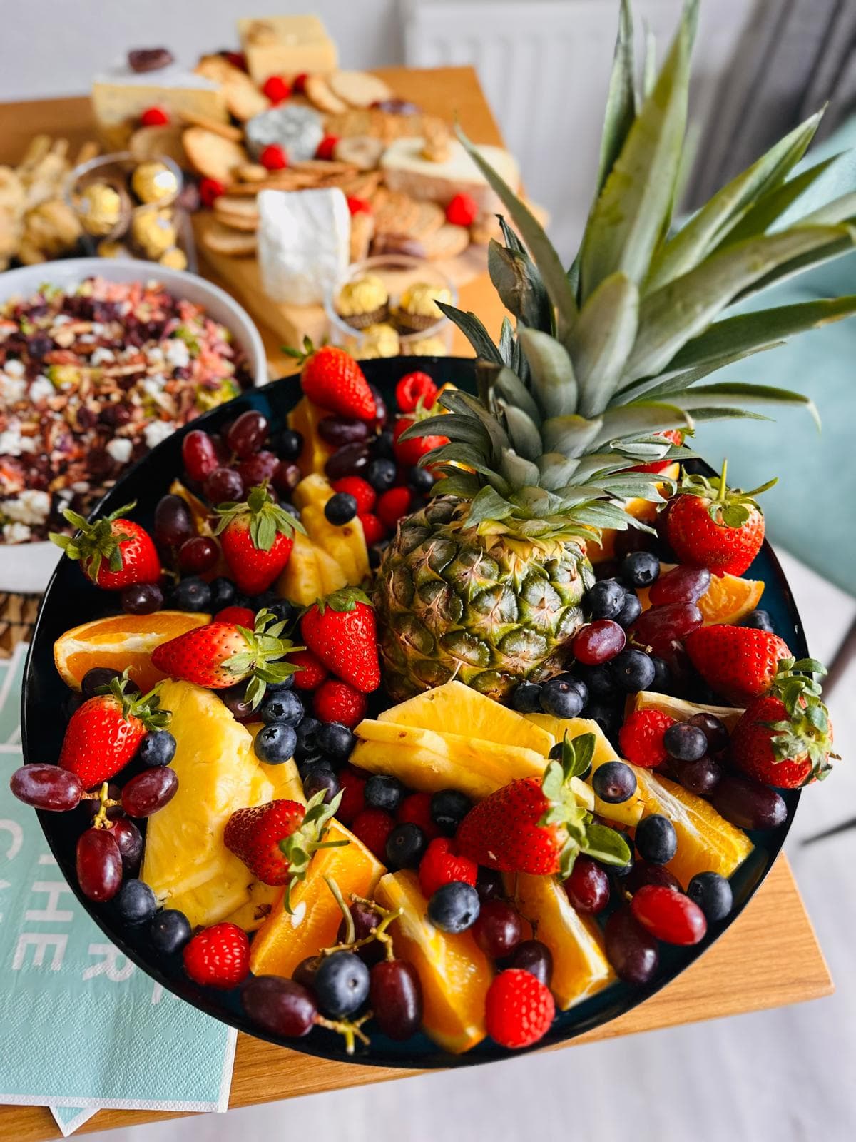 A fruit platter with pineapple, berries and citrus